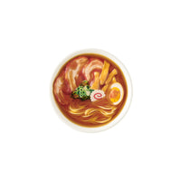 Bowl of ramen with noodles, egg, and vegetables on a white background